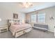 Comfortable main bedroom features a blush quilt, sitting area, and natural light at 326 Beethoven Ridge Dr, Henderson, NV 89011