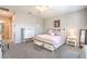 Stylish main bedroom features a blush quilt, carpeted floors, and barn door accents at 326 Beethoven Ridge Dr, Henderson, NV 89011