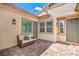 Inviting outdoor patio featuring neutral-toned furniture, brick pavers, and multiple entryways, on a beautiful sunny day at 326 Beethoven Ridge Dr, Henderson, NV 89011