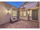 Inviting outdoor patio featuring neutral-toned furniture, brick pavers, and multiple entryways, ideal for relaxation and entertainment at 326 Beethoven Ridge Dr, Henderson, NV 89011