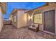 Inviting outdoor patio featuring neutral-toned furniture, brick pavers, and multiple entryways, ideal for relaxation and entertainment at 326 Beethoven Ridge Dr, Henderson, NV 89011