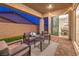 Relaxing covered patio features an outdoor seating area with plush cushions and stylish decor at 326 Beethoven Ridge Dr, Henderson, NV 89011