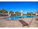 Sparkling outdoor pool surrounded by lush greenery and comfortable seating, perfect for summer relaxation at 326 Beethoven Ridge Dr, Henderson, NV 89011