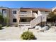 Condo exterior with small patio, second story balcony and desert landscaping with decorative rocks at 3811 Desert Marina Dr # 125, Laughlin, NV 89029