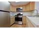 Kitchen featuring stainless steel appliances, light wood cabinetry, and stone countertops at 3811 Desert Marina Dr # 125, Laughlin, NV 89029