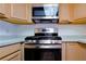 Close-up shot of modern stainless steel stove and oven combo with light wood cabinetry at 3811 Desert Marina Dr # 125, Laughlin, NV 89029