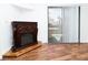 Living room showcasing a decorative fireplace, wood-look flooring, and sliding glass door at 3811 Desert Marina Dr # 125, Laughlin, NV 89029