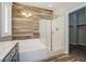 Modern bathroom with a glass shower, soaking tub, and decorative tiling at 3820 Alpine Track Ave, North Las Vegas, NV 89032