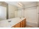 Bathroom with a double sink vanity, shower/tub combo, and large mirror at 3820 Alpine Track Ave, North Las Vegas, NV 89032