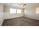 Spacious bedroom featuring neutral paint, large windows with blinds, and a ceiling fan at 3820 Alpine Track Ave, North Las Vegas, NV 89032