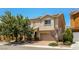 Inviting two-story home with a brick driveway and mature landscaping at 3820 Alpine Track Ave, North Las Vegas, NV 89032