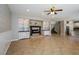 Open-concept living room with tile flooring, custom fireplace, and stylish lighting at 3820 Alpine Track Ave, North Las Vegas, NV 89032
