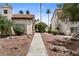 Image of the community clubhouse with lush desert landscaping around a sidewalk at 3923 Gogo Way # 106, Las Vegas, NV 89103