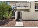 Front exterior with iron gate, garden area, and stairs leading to unit 105 at 3923 Gogo Way # 106, Las Vegas, NV 89103