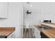 Bright open kitchen with wood countertops, white cabinets, stainless sink, and eating area at 3923 Gogo Way # 106, Las Vegas, NV 89103