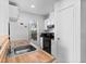 Kitchen featuring wood countertop, stainless steel sink, black appliances and white cabinets at 3923 Gogo Way # 106, Las Vegas, NV 89103