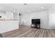 Bright living room featuring modern flooring, dining area, and mounted television at 3923 Gogo Way # 106, Las Vegas, NV 89103