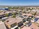 A high-angle view shows a residential area, highlighting uniform homes with tile roofs and organized street layouts at 4212 Juanita May Ave, North Las Vegas, NV 89032