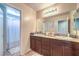 Bathroom featuring granite counters, double sinks, and a nearby shower at 4212 Juanita May Ave, North Las Vegas, NV 89032