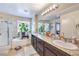 Bright bathroom featuring double sinks, a tub, and walk-in shower at 4212 Juanita May Ave, North Las Vegas, NV 89032