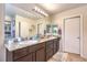 Bathroom featuring granite counters, double sinks, and neutral-toned cabinetry at 4212 Juanita May Ave, North Las Vegas, NV 89032