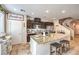Charming kitchen with dark cabinetry, stainless appliances, tile floor and center island with seating at 4212 Juanita May Ave, North Las Vegas, NV 89032