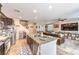 Open-concept kitchen flows into the living room with dark cabinetry and island seating at 4212 Juanita May Ave, North Las Vegas, NV 89032