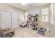 Comfortable room with tile floor, cat trees, chair, and closet with sliding doors at 4212 Juanita May Ave, North Las Vegas, NV 89032