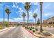 Street view showcases a community entrance with palm trees against a blue sky at 4212 Juanita May Ave, North Las Vegas, NV 89032