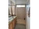 Bathroom featuring a tiled walk-in shower, a sink, and a window at 425 Ross Ave, Overton, NV 89040