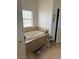 Bathroom with a jetted tub, tiled surround, and natural lighting at 425 Ross Ave, Overton, NV 89040