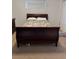 Bedroom with a dark wood sleigh bed and a neutral color scheme at 425 Ross Ave, Overton, NV 89040