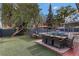 Spacious backyard with an outdoor dining area, lounge chairs, and a well-maintained turf at 4330 Flandes St, Las Vegas, NV 89121