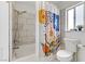 Bathroom with tiled shower, modern shower curtain, and toilet at 4330 Flandes St, Las Vegas, NV 89121