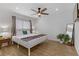Brightly lit bedroom featuring hardwood floors, ceiling fan, and a large window at 4330 Flandes St, Las Vegas, NV 89121
