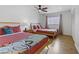 Bright bedroom featuring two beds, hardwood floors, and a ceiling fan at 4330 Flandes St, Las Vegas, NV 89121
