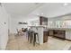 Open-concept kitchen and dining area featuring dark cabinetry, granite countertops, and bar seating at 4330 Flandes St, Las Vegas, NV 89121