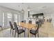 Bright dining room with modern lighting, a sleek table, and easy access to the kitchen and outdoor area at 4330 Flandes St, Las Vegas, NV 89121