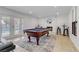 Entertaining game room featuring a pool table, fireplace, and access to the outdoor pool area at 4330 Flandes St, Las Vegas, NV 89121