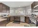Well-equipped kitchen with sleek stainless steel appliances, ample counter space, and dark wood cabinetry at 4330 Flandes St, Las Vegas, NV 89121