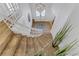 Bright foyer with wooden staircase leading to the second floor, featuring a modern light fixture at 4330 Flandes St, Las Vegas, NV 89121