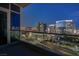 Enjoy the city skyline view from the condo balcony, featuring glass railings and an illuminated cityscape at night at 4575 Dean Martin Dr # 2607, Las Vegas, NV 89103
