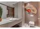 Stylish bathroom featuring modern fixtures, elegant marble flooring, and a unique decorative fan at 4575 Dean Martin Dr # 2607, Las Vegas, NV 89103