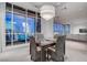 Dining area with wicker chairs and a view of the city skyline through large windows at 4575 Dean Martin Dr # 2607, Las Vegas, NV 89103