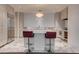 Modern kitchen with a large island and red leather bar stool seating at 4575 Dean Martin Dr # 2607, Las Vegas, NV 89103