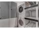 Utility room with stacked washer and dryer and shelving storage at 4575 Dean Martin Dr # 2607, Las Vegas, NV 89103