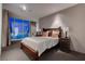 Cozy bedroom with a decorative wood bed frame, soft lighting, and expansive windows for natural light at 4575 Dean Martin Dr # 2607, Las Vegas, NV 89103