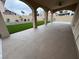 Covered backyard patio with artificial turf and well-maintained landscaping, perfect for outdoor entertaining at 5040 Jacarilla Ln, North Las Vegas, NV 89031
