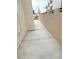 Wide side yard with concrete, stucco wall, and space for outdoor activities or storage at 5040 Jacarilla Ln, North Las Vegas, NV 89031