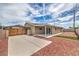 Backyard featuring a covered patio, carport, and low-maintenance gravel landscaping at 5203 Treasure Ave, Las Vegas, NV 89122
